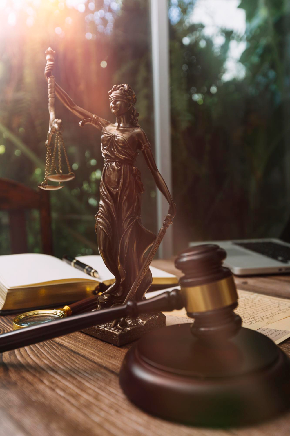 Lady Justice statue with gavel — legal counsel
